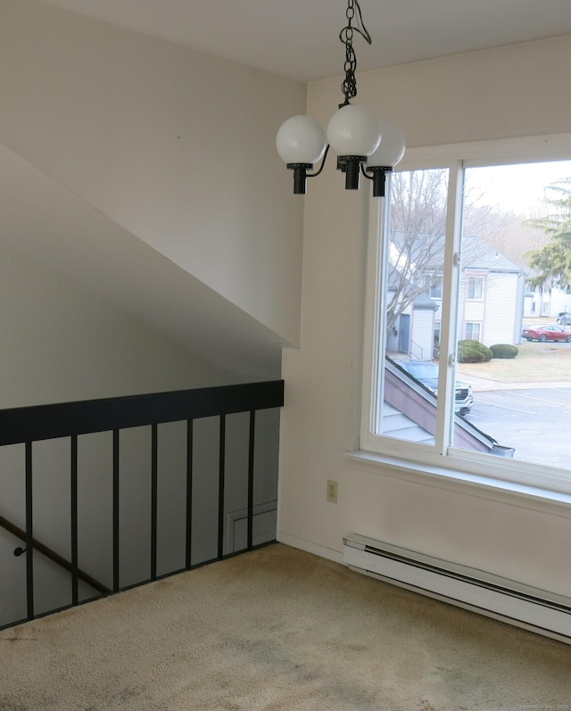 interior space with carpet, baseboard heating, and a notable chandelier