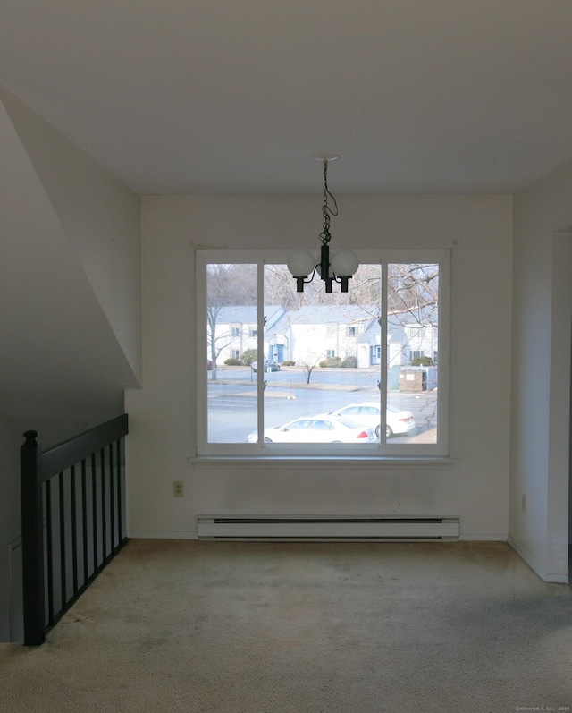 dining space with plenty of natural light, a baseboard radiator, light carpet, and a notable chandelier