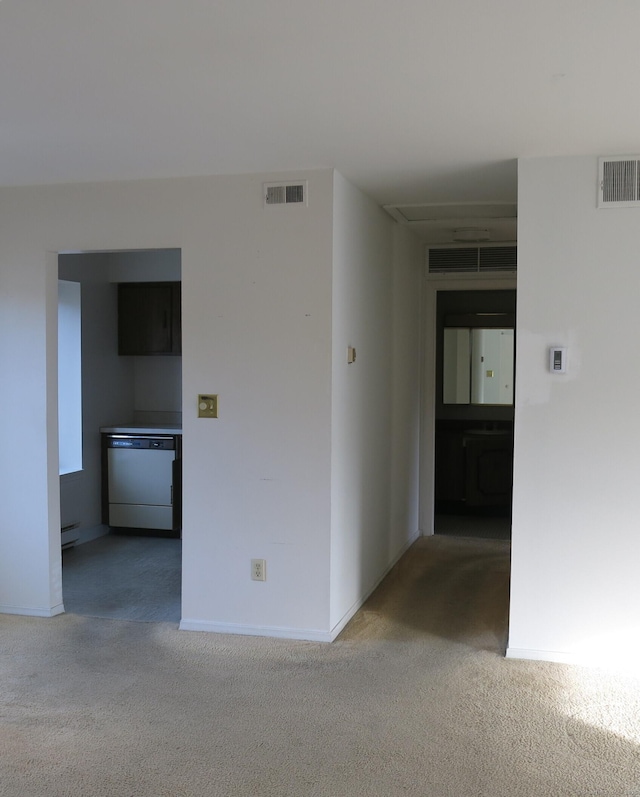 carpeted empty room featuring baseboard heating