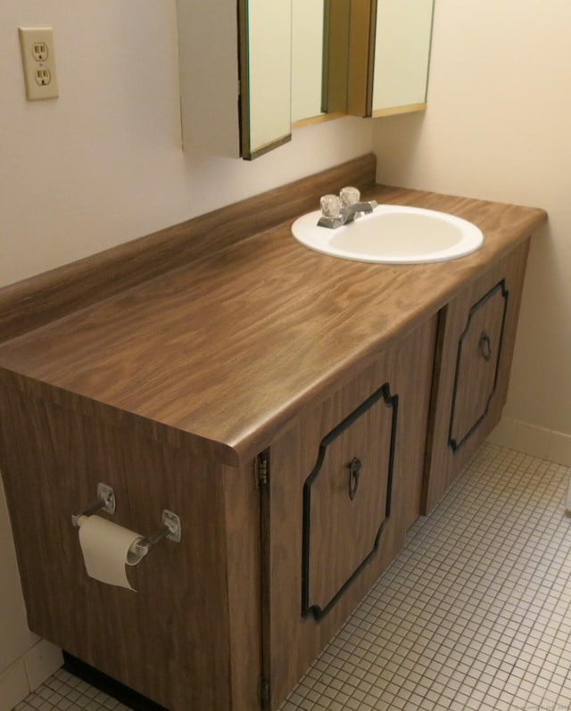 bathroom with tile patterned flooring and vanity