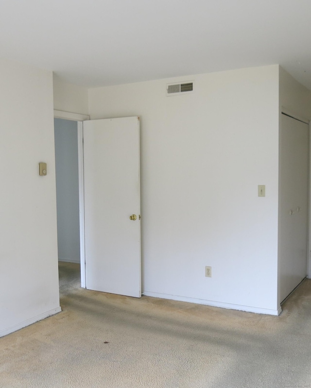 empty room featuring light carpet