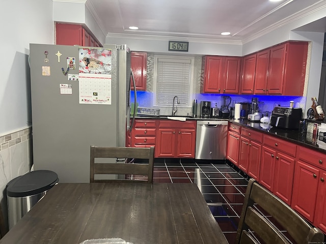 kitchen with appliances with stainless steel finishes, dark hardwood / wood-style floors, crown molding, and sink