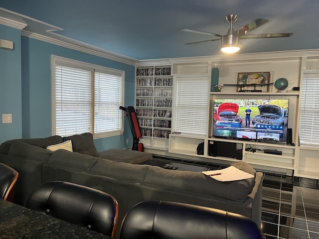 living room with ceiling fan and ornamental molding