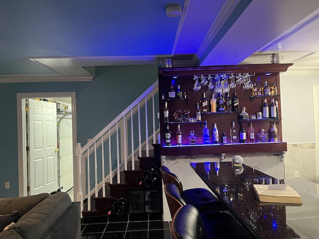 bar with tile patterned flooring and ornamental molding