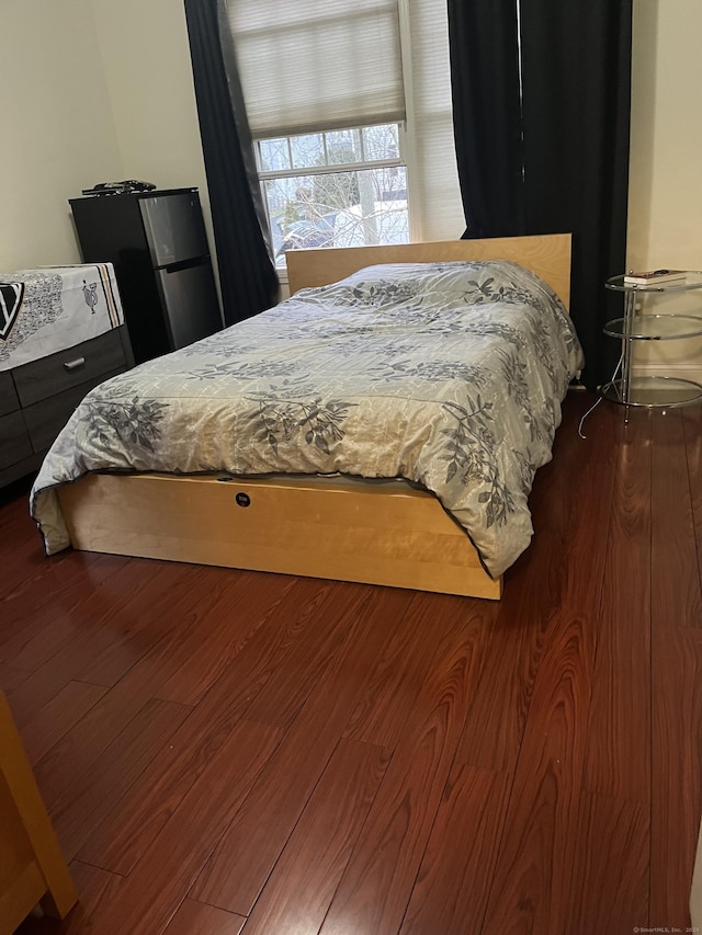 bedroom with dark hardwood / wood-style floors