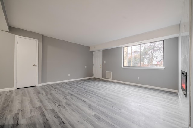 empty room with light hardwood / wood-style floors