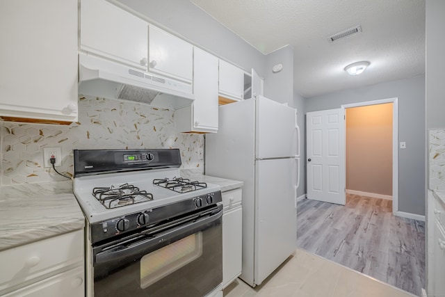 kitchen with a textured ceiling, decorative backsplash, white cabinetry, and black gas range oven