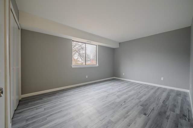 unfurnished room with light hardwood / wood-style floors