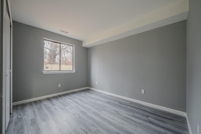 empty room with light hardwood / wood-style flooring