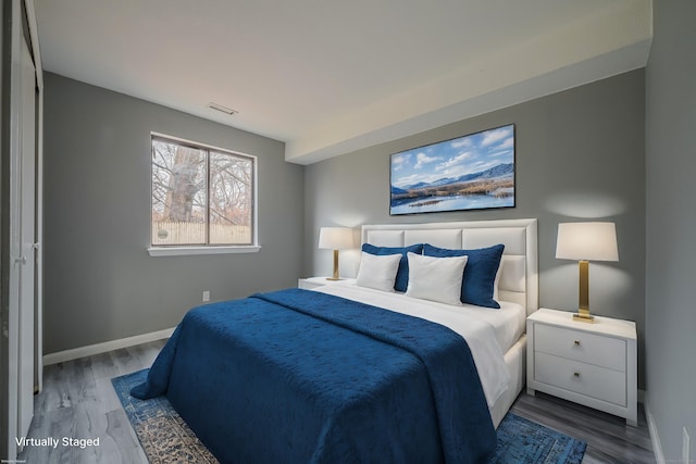 bedroom with hardwood / wood-style flooring