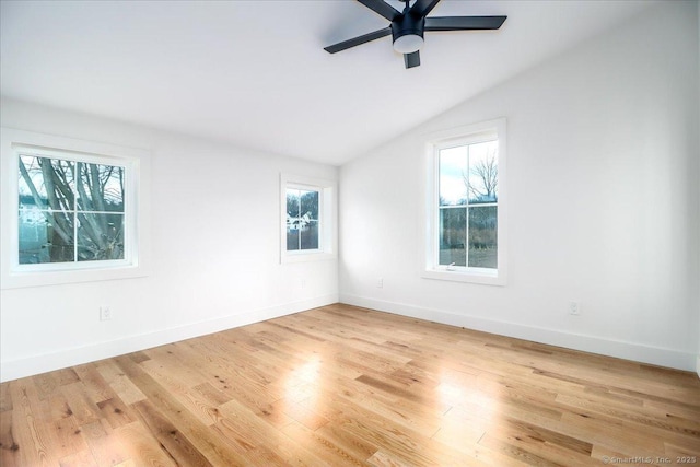 unfurnished room with ceiling fan, light hardwood / wood-style flooring, and vaulted ceiling