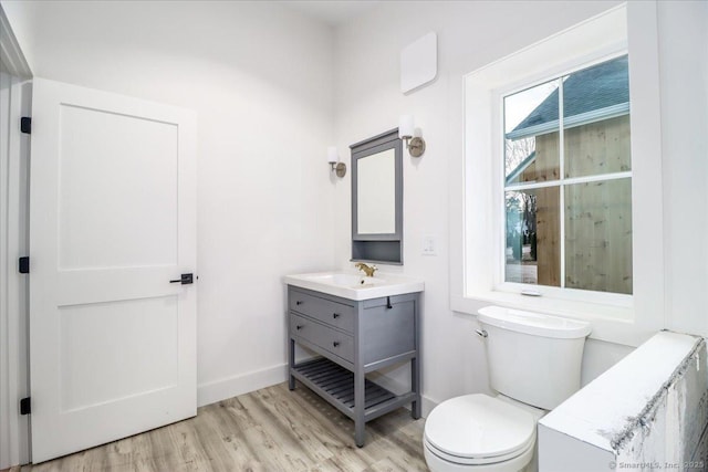 bathroom featuring hardwood / wood-style flooring, vanity, and toilet