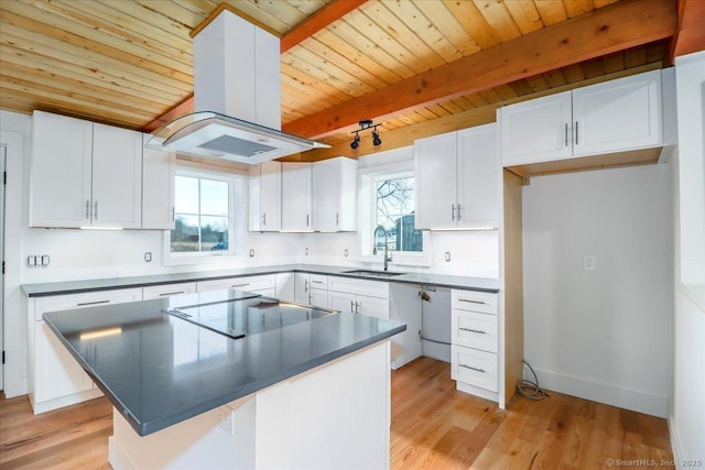 kitchen with white cabinets, a center island, and island range hood