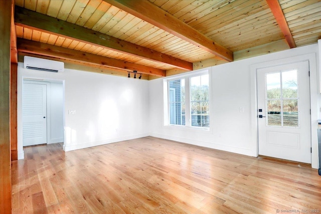 interior space with a wall mounted AC, a healthy amount of sunlight, beamed ceiling, and wooden ceiling