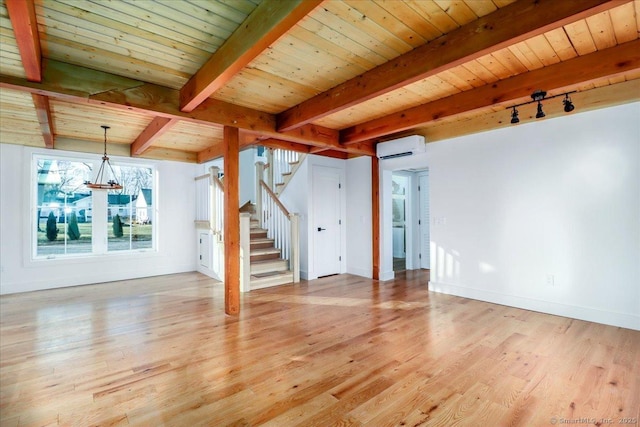 interior space featuring a wall mounted AC, a chandelier, wood ceiling, and light wood-type flooring