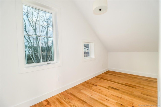 bonus room featuring hardwood / wood-style floors, plenty of natural light, and lofted ceiling