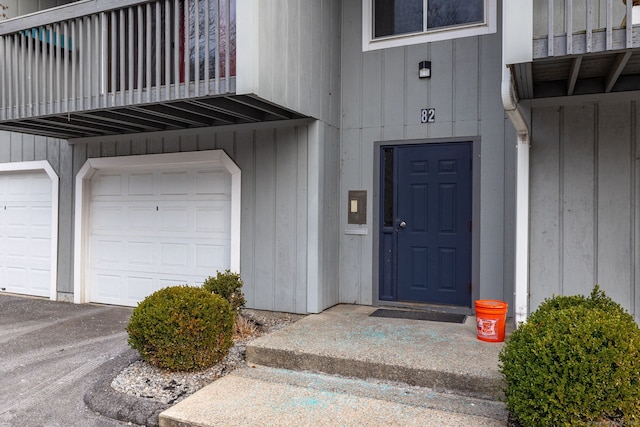 entrance to property featuring a balcony and a garage