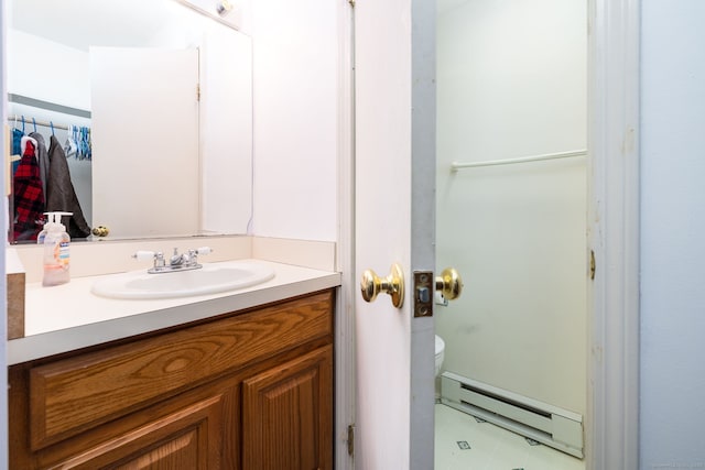 bathroom featuring baseboard heating, vanity, and toilet