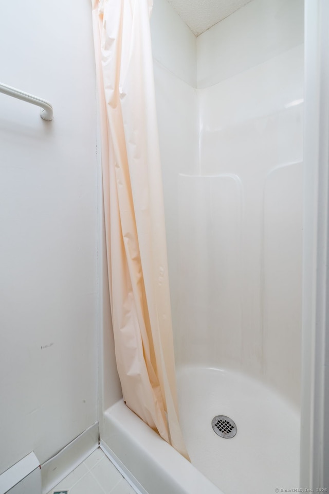 bathroom with a shower with shower curtain