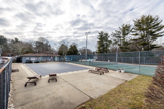 view of swimming pool featuring tennis court