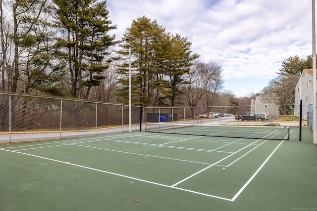 view of tennis court featuring basketball hoop