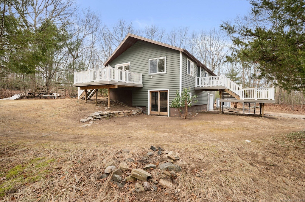 back of house featuring a deck