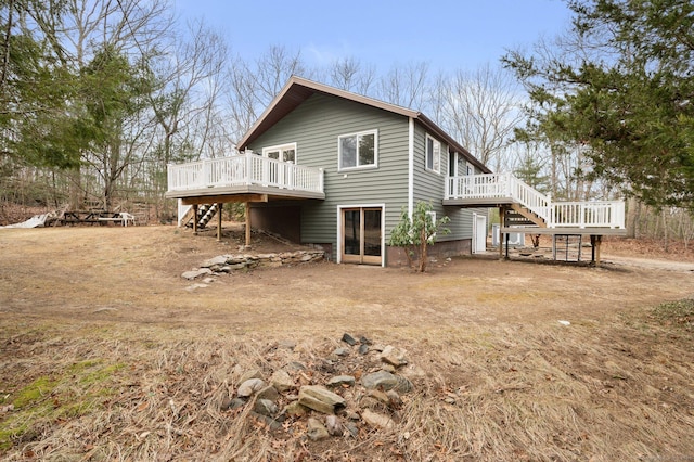 back of house featuring a deck