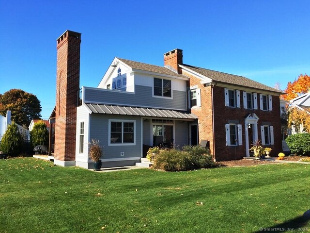 rear view of house with a yard