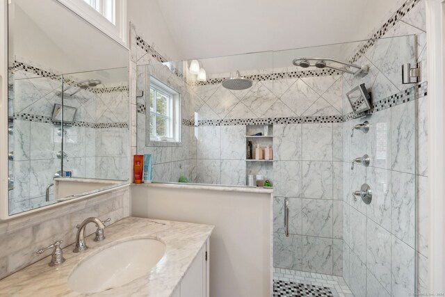 bathroom with vanity and a shower with shower door