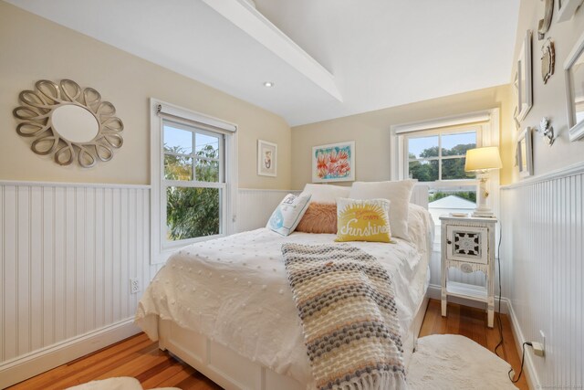 bedroom with multiple windows and hardwood / wood-style floors