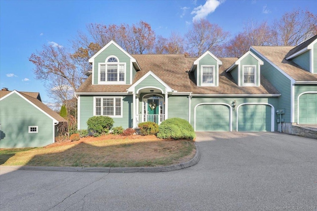 cape cod home with a garage