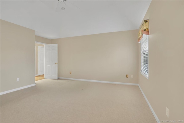 empty room with ceiling fan and light colored carpet