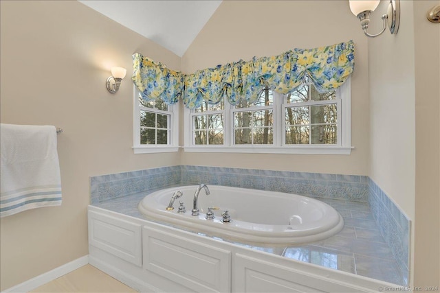 bathroom with a bath and vaulted ceiling