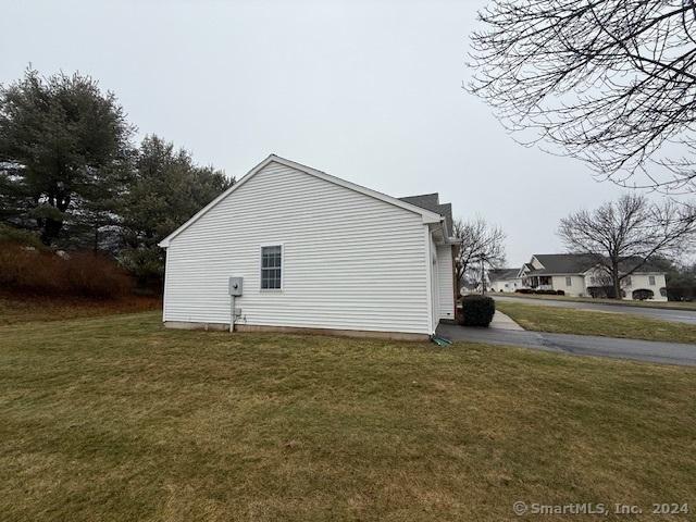 view of side of property featuring a yard