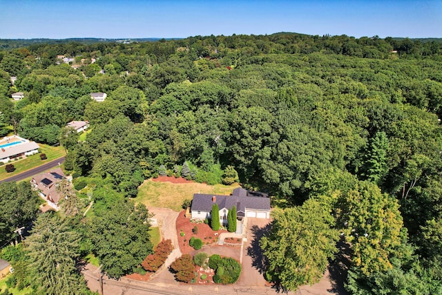 drone / aerial view featuring a view of trees