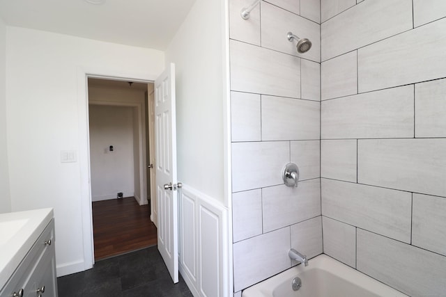 full bathroom featuring vanity, shower / bath combination, and baseboards