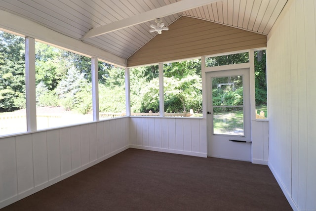 unfurnished sunroom featuring vaulted ceiling with beams