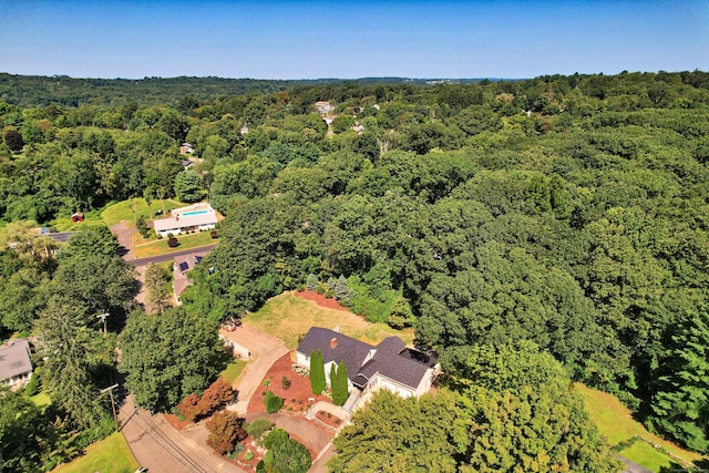 aerial view featuring a wooded view