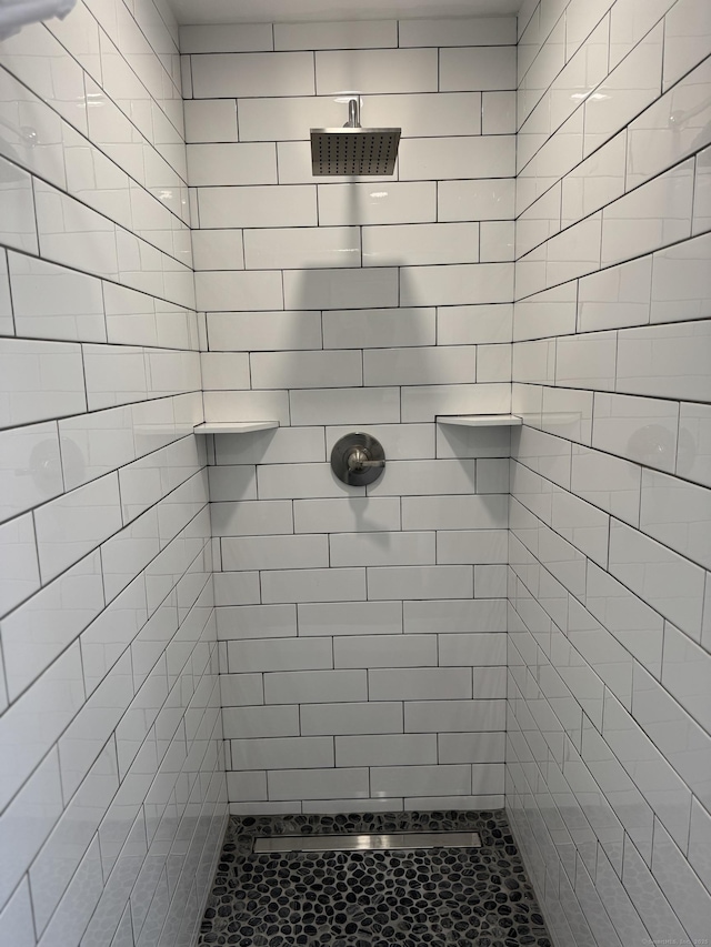 bathroom with tiled shower