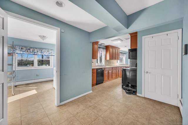 kitchen featuring black dishwasher, light tile patterned floors, and baseboard heating