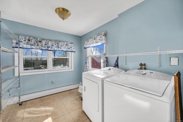 laundry room featuring washer and clothes dryer, a baseboard radiator, and light tile patterned flooring