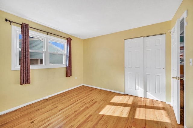 unfurnished bedroom featuring hardwood / wood-style floors and a closet