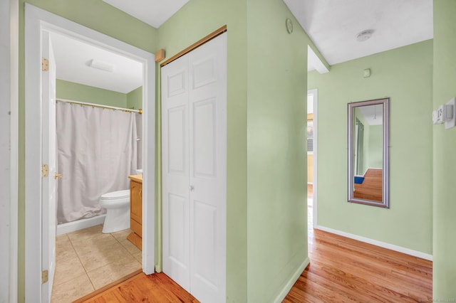 hall featuring light tile patterned flooring