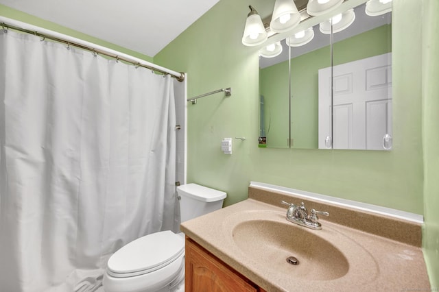 bathroom with vanity, curtained shower, and toilet