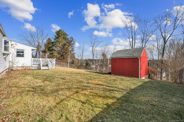 view of yard featuring a shed and a deck