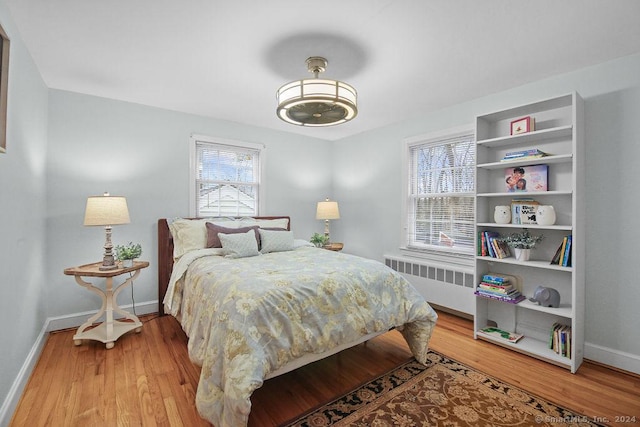 bedroom with wood-type flooring and radiator