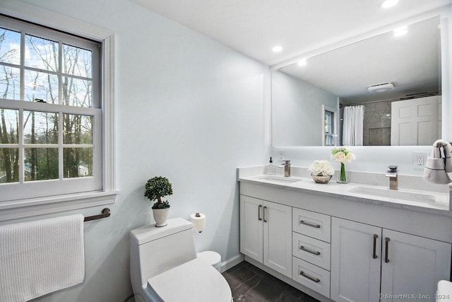 bathroom with vanity, toilet, and walk in shower