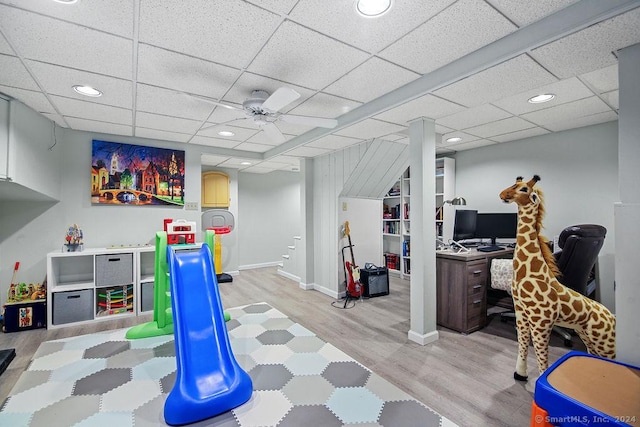 rec room featuring a paneled ceiling, ceiling fan, and light hardwood / wood-style floors