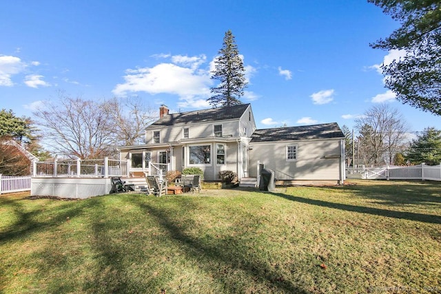 back of house featuring a yard and a wooden deck