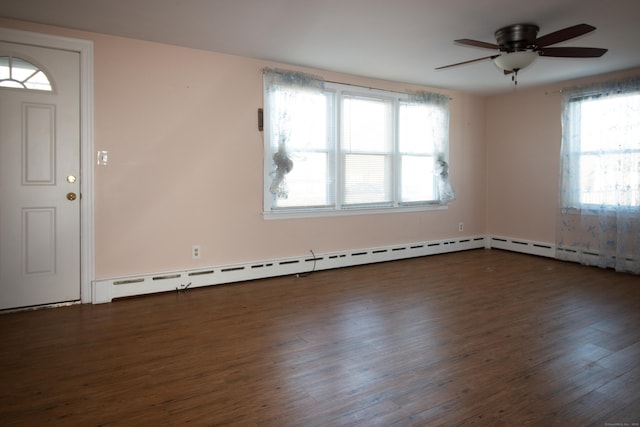 interior space featuring baseboard heating, ceiling fan, dark hardwood / wood-style flooring, and a healthy amount of sunlight